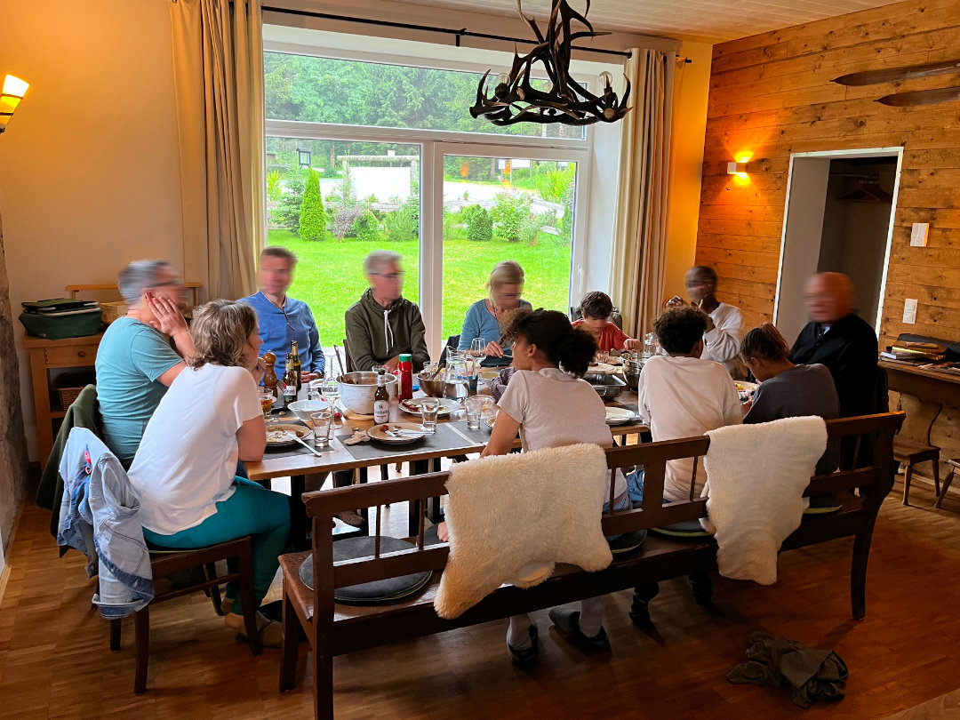 Familie im Gemeinschaftsraum Familie und Freunde sitzen im Gemeinschaftsraum der Berghütte Zum Kranichsee
